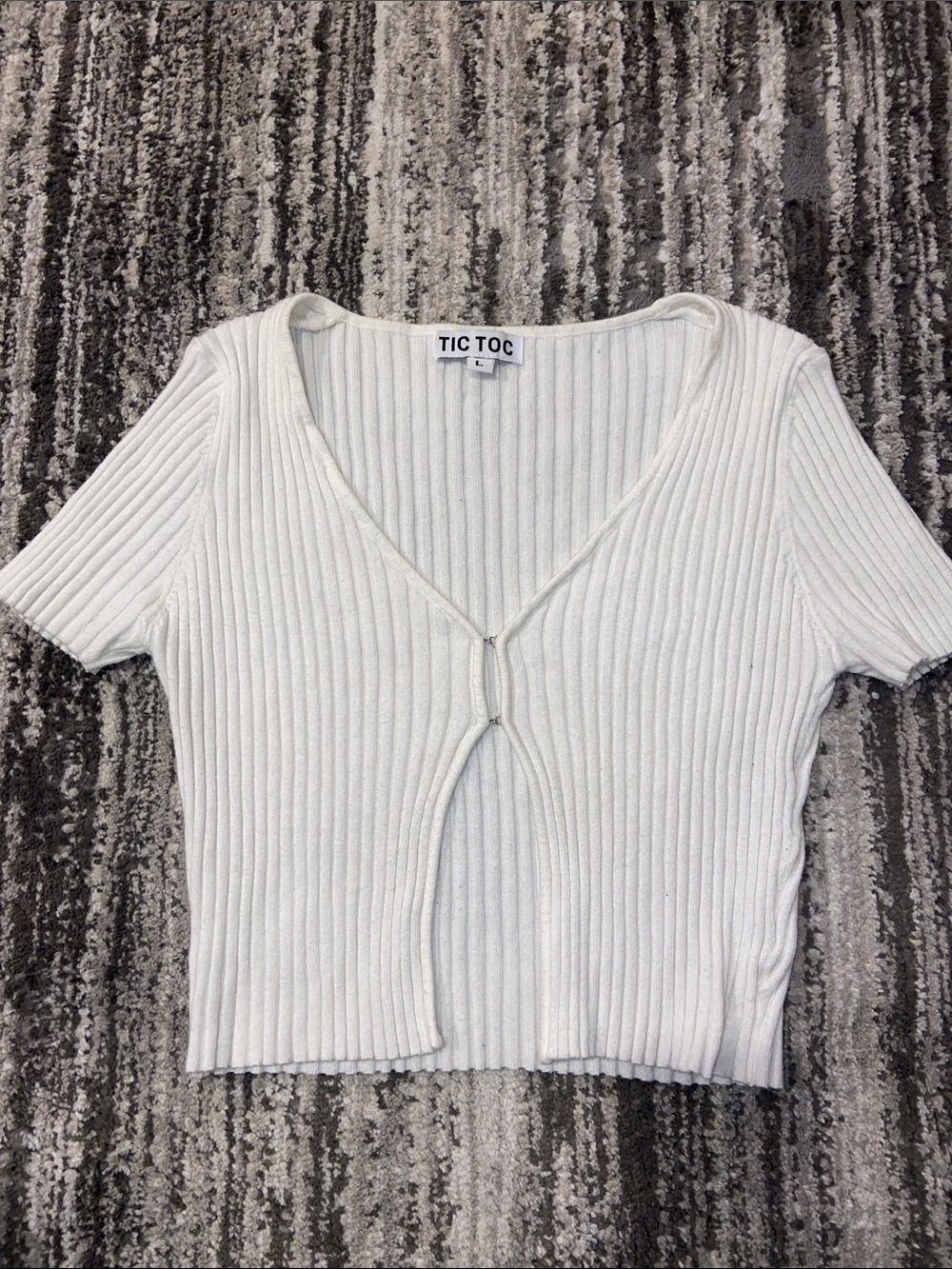 Tic Toc ribbed top featuring a front clasp closure